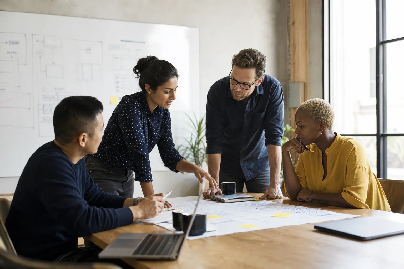 An inclusive group of adult technology professionals collaborating in a product planning session